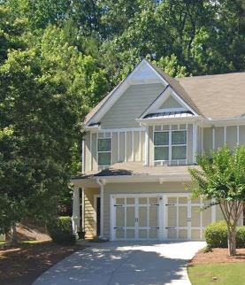 A house with a white garage door and a brown roof.