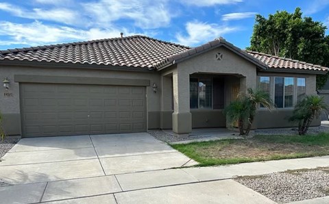 A house with a garage door and a driveway.