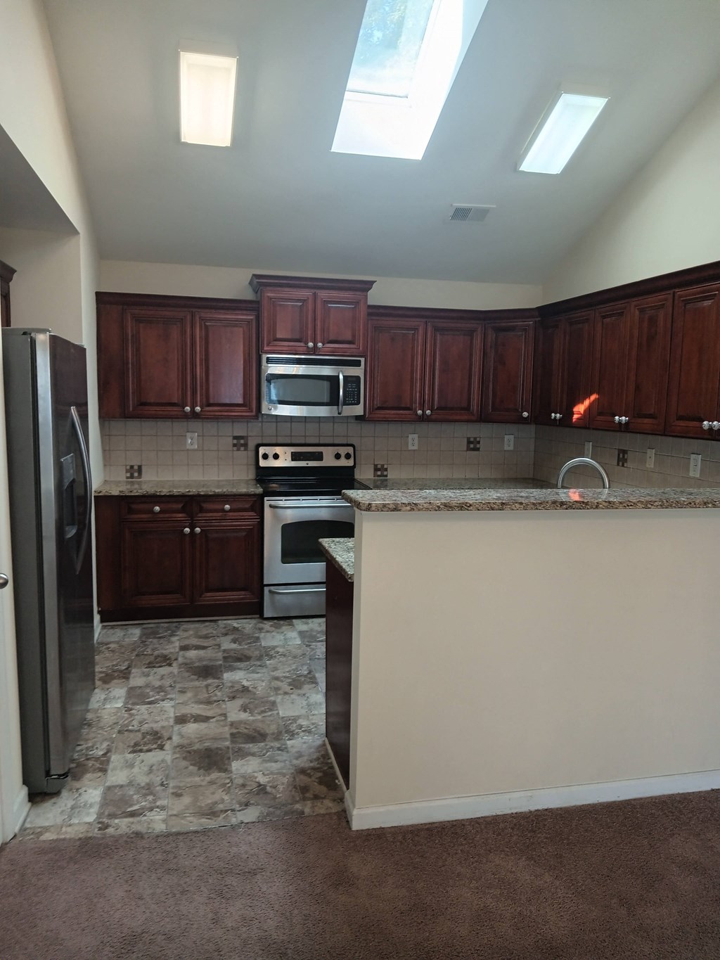 a kitchen with wooden cabinets and a counter top