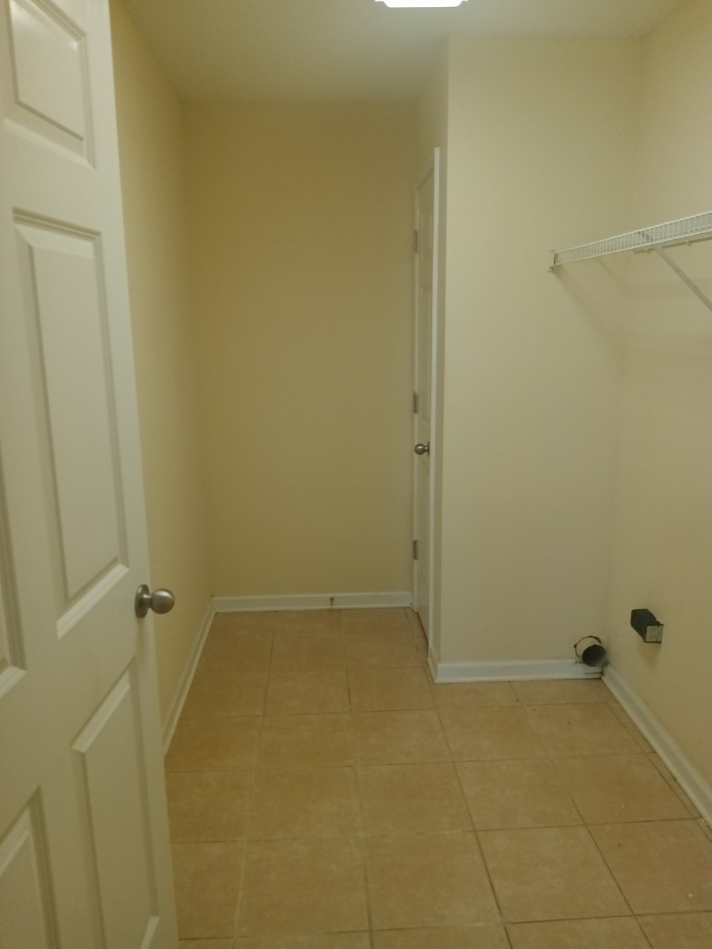 a room with a closet and a hallway with a door