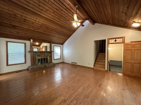 A room with wooden floors and a fireplace.