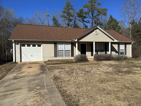 A house with a brown roof and a garage door.