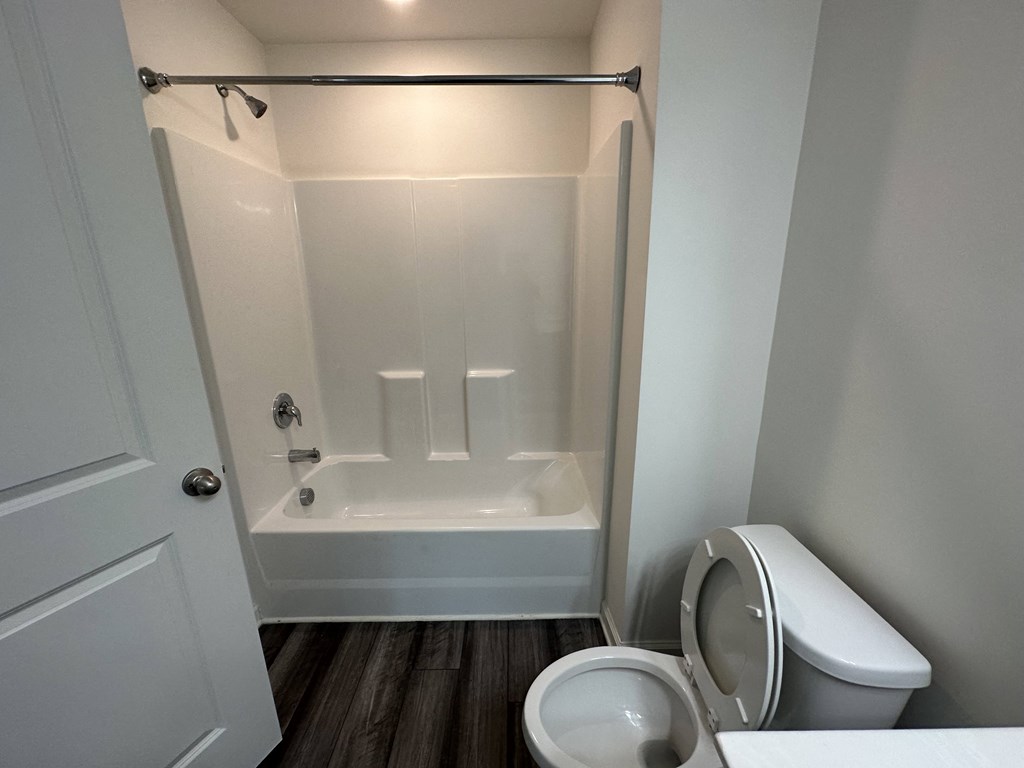 a small bathroom with a toilet and a shower