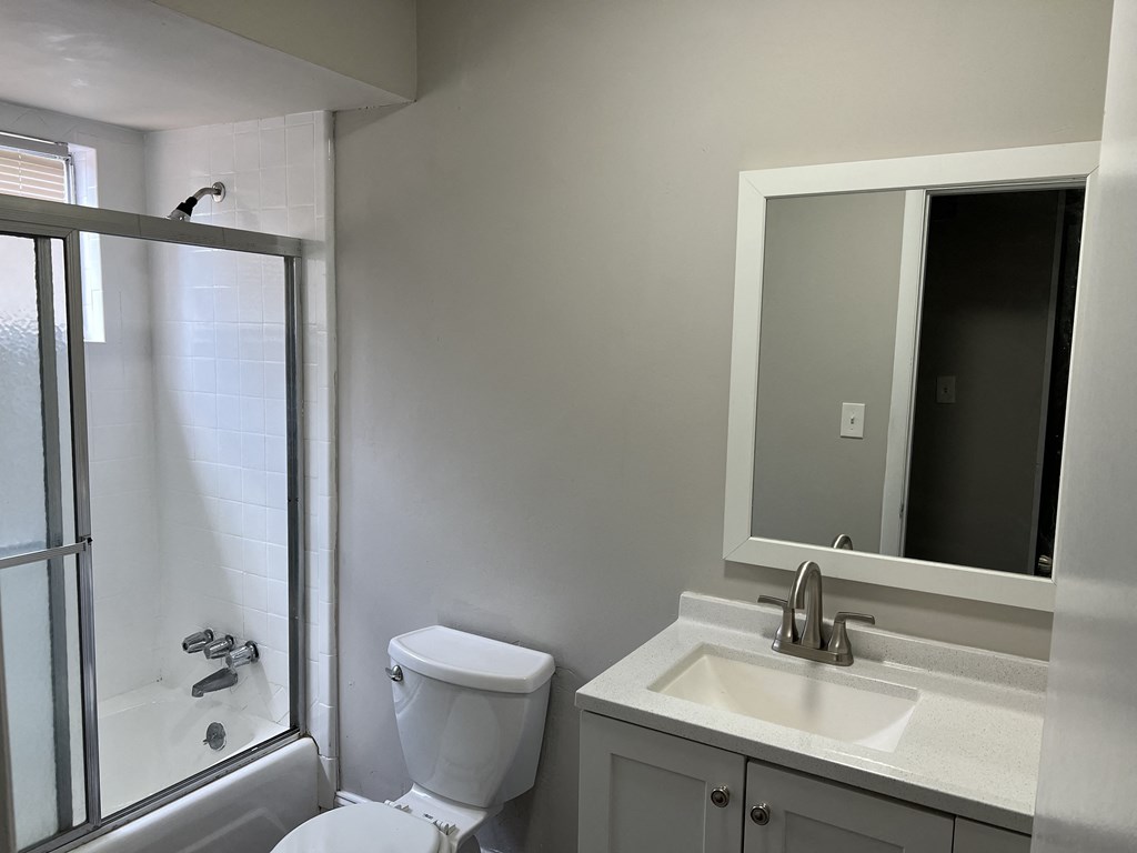 a small bathroom with a sink toilet and shower