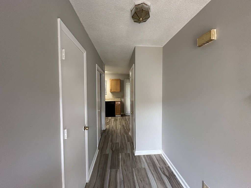 our apartments have a hallway with wood floors and white walls