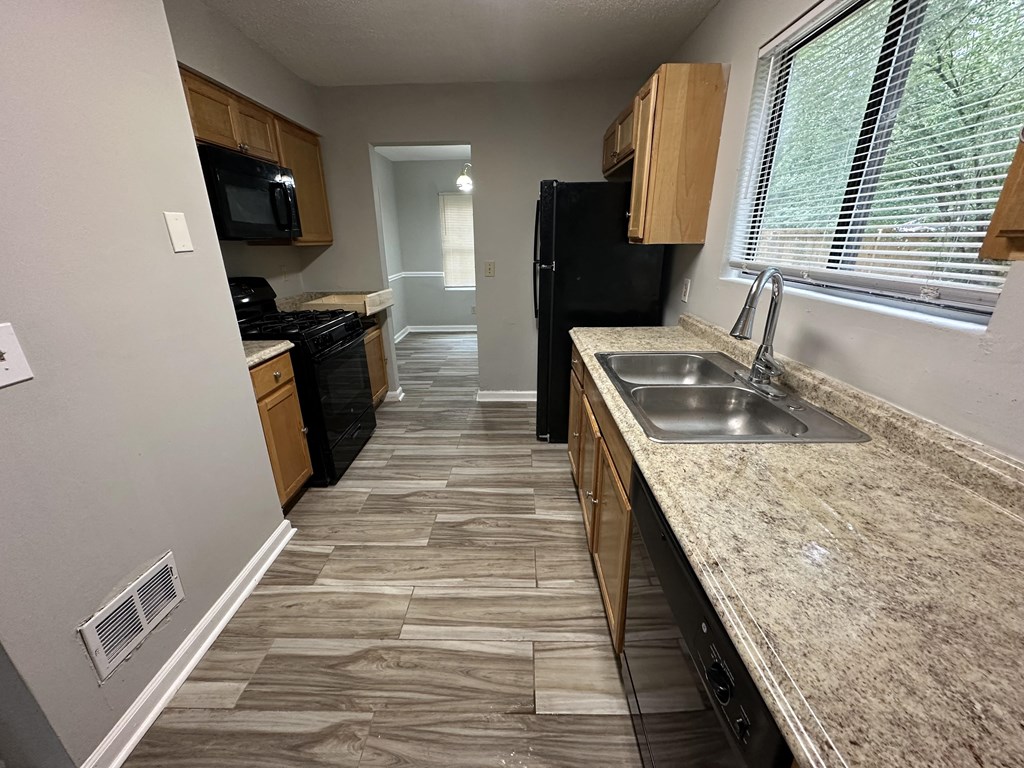 a kitchen with a sink and a window