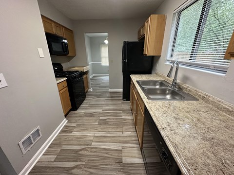 a kitchen with a sink and a window