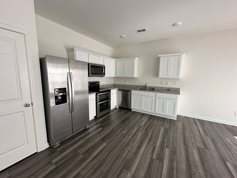 a kitchen with stainless steel appliances and white cabinets