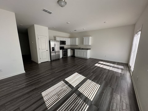 an empty living room and kitchen in a new home