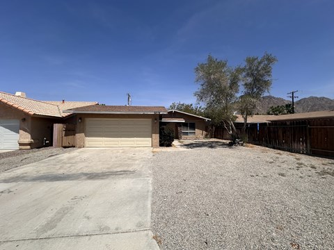 a house with a gravel driveway and a garage door