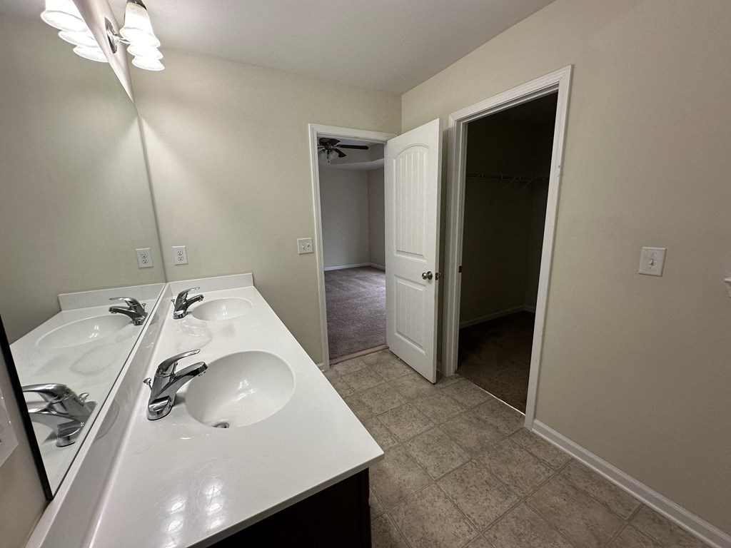 an empty bathroom with a sink and a mirror