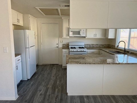 a kitchen with a stove and a refrigerator
