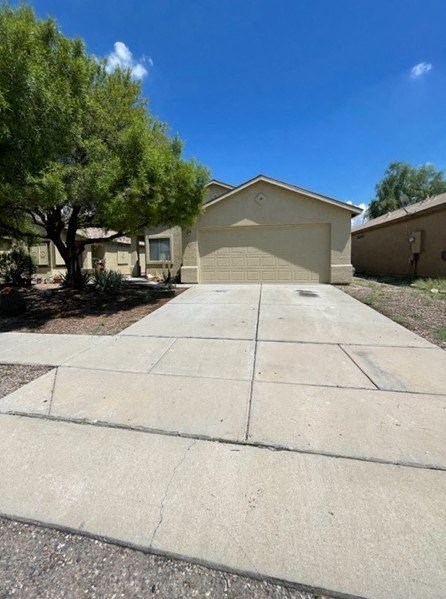 a driveway in front of a house with a garage door