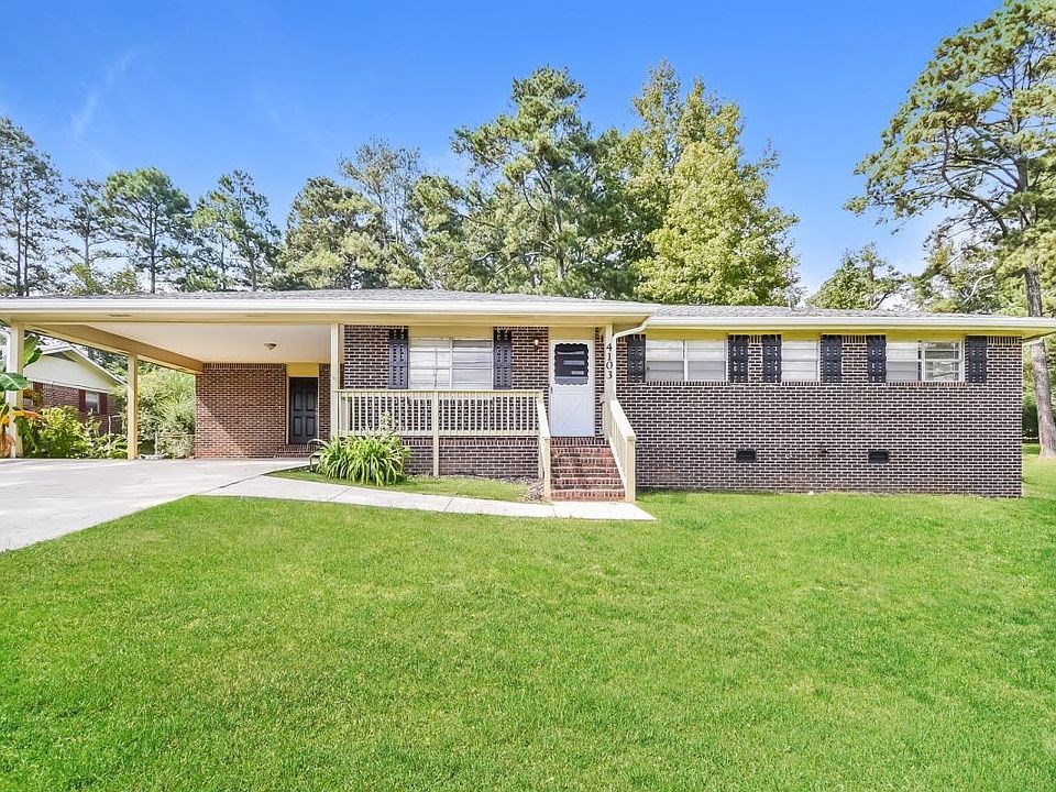 A house with a green lawn in front.