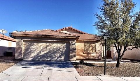 A house with a brown roof and a garage door.