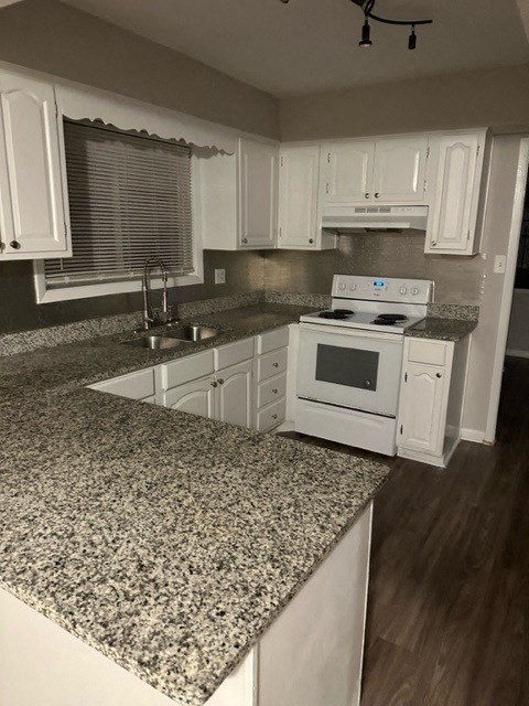 a kitchen with white cabinets and granite counter tops