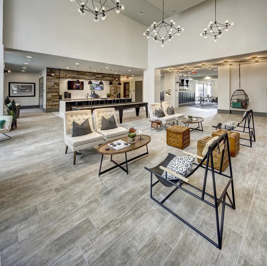 A spacious lobby with a variety of seating options and a bar area at Arise Riverside Apartments, Texas 78741