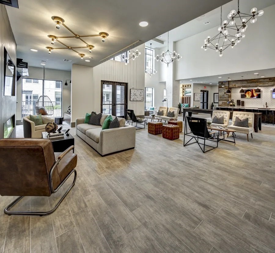 A modern living room with a wooden floor and a fireplace at Arise Riverside Apartments, Austin, 78741