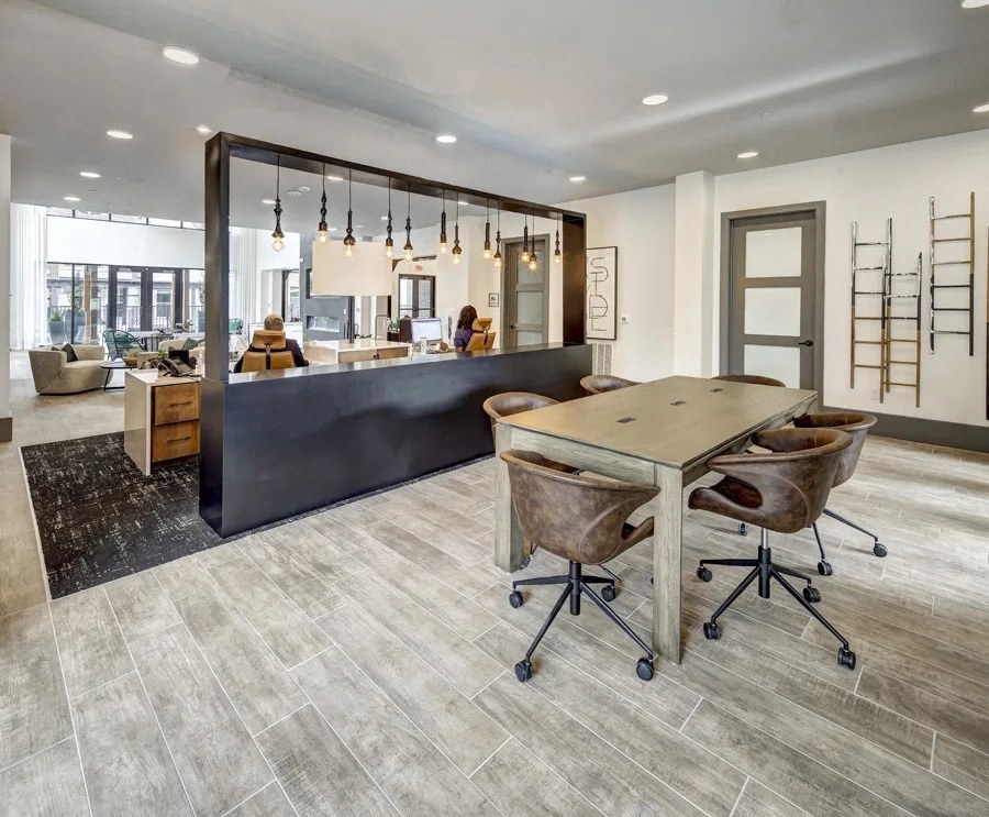 A modern office space with a long table and chairs at Arise Riverside Apartments, Austin