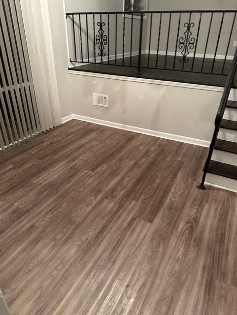 a room with a staircase and a wood floor