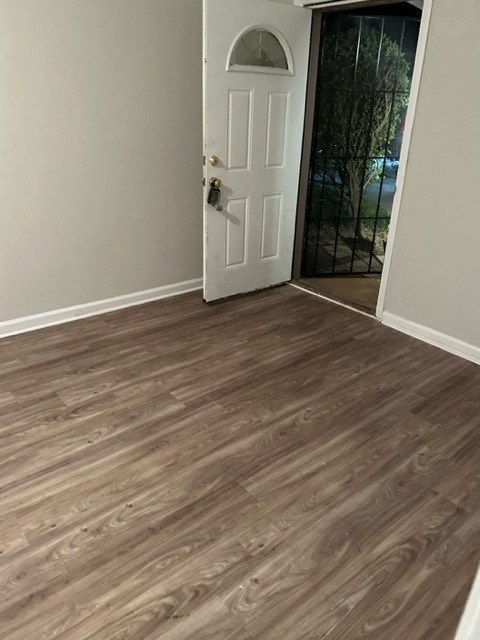 a room with a wooden floor and a white door