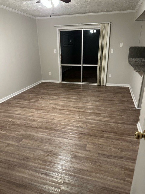 a living room with a hard wood floor and a door
