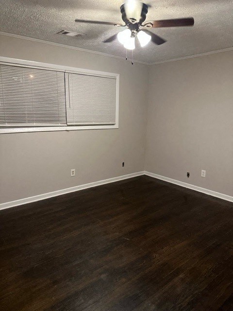 an empty room with a ceiling fan and a window