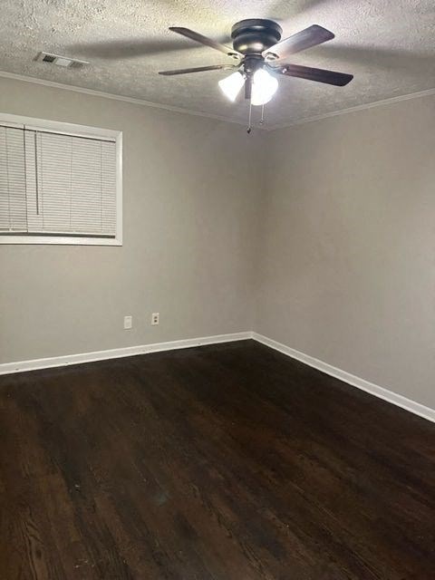 an empty room with a ceiling fan and a window