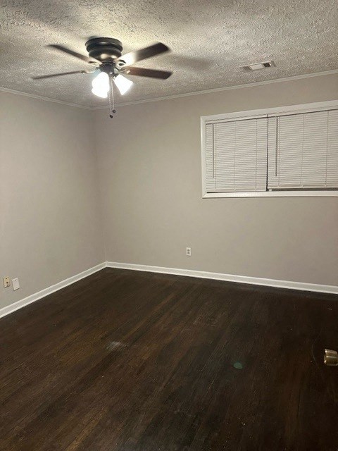 an empty room with a ceiling fan and a window