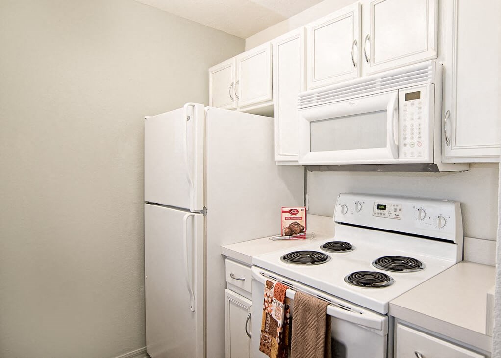 a kitchen with a stove microwave and refrigerator
