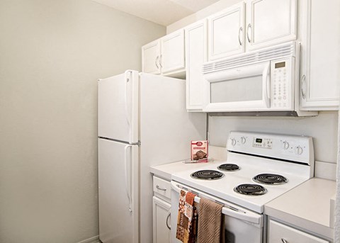 a kitchen with a stove microwave and refrigerator