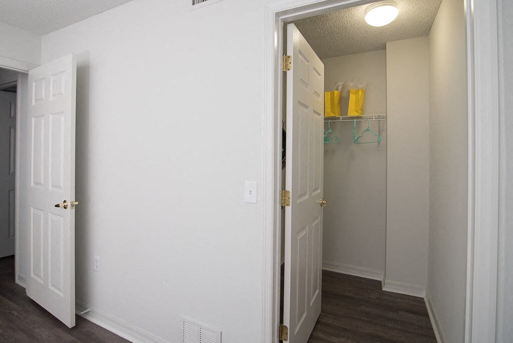 a bedroom with a closet and a door open