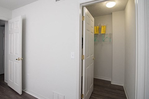 a bedroom with a closet and a door open