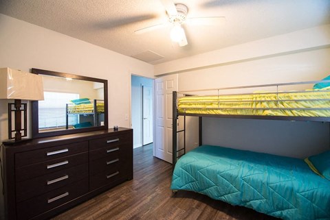 a bedroom with a bunk bed and a dresser