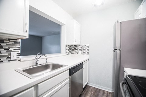 a kitchen with a sink and a refrigerator