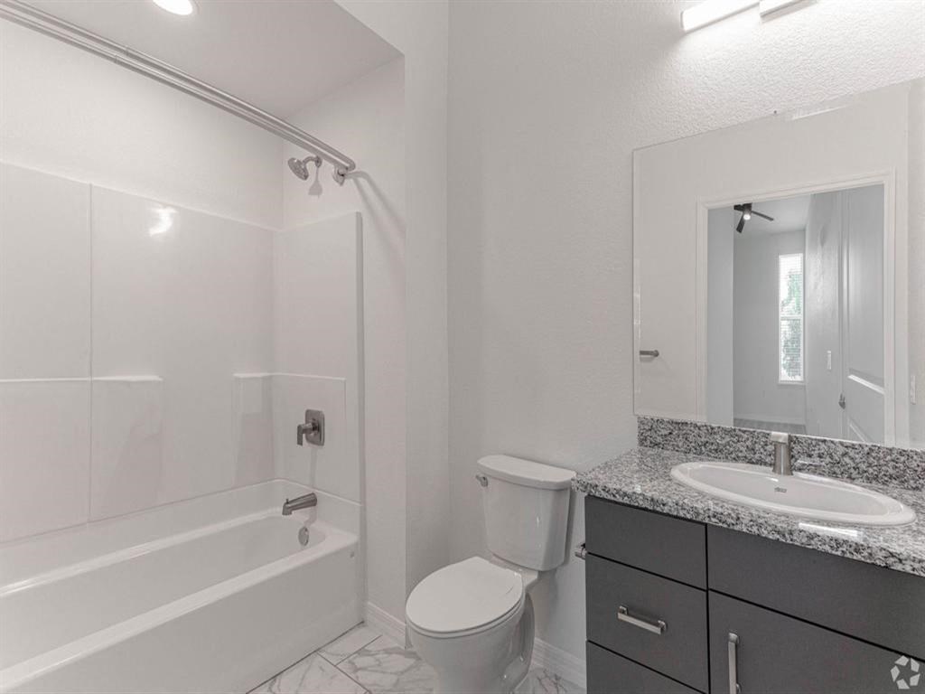 a bathroom with a sink toilet and a bath tub