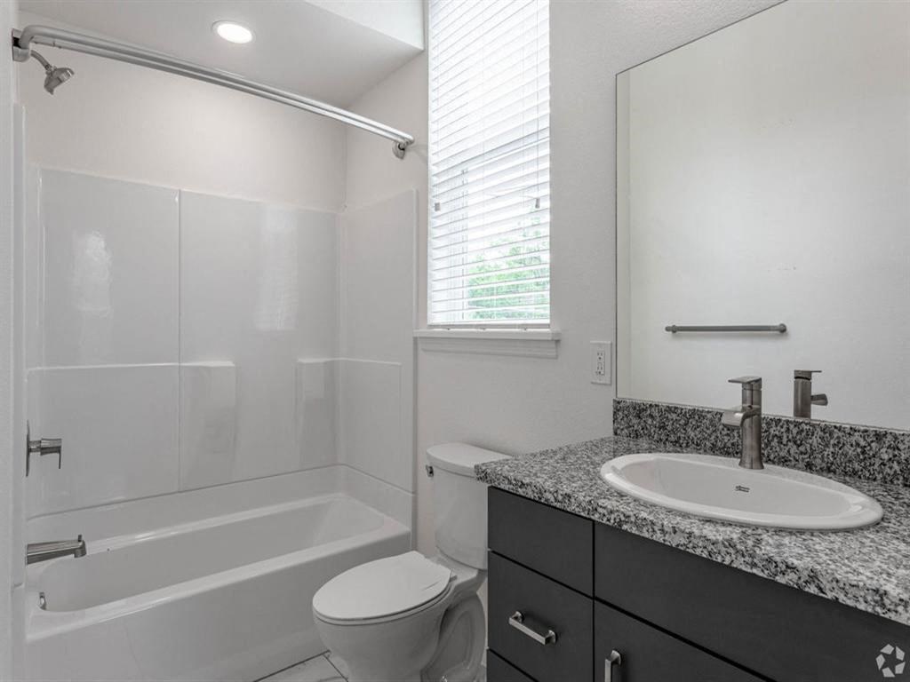 a bathroom with a sink toilet and a bath tub