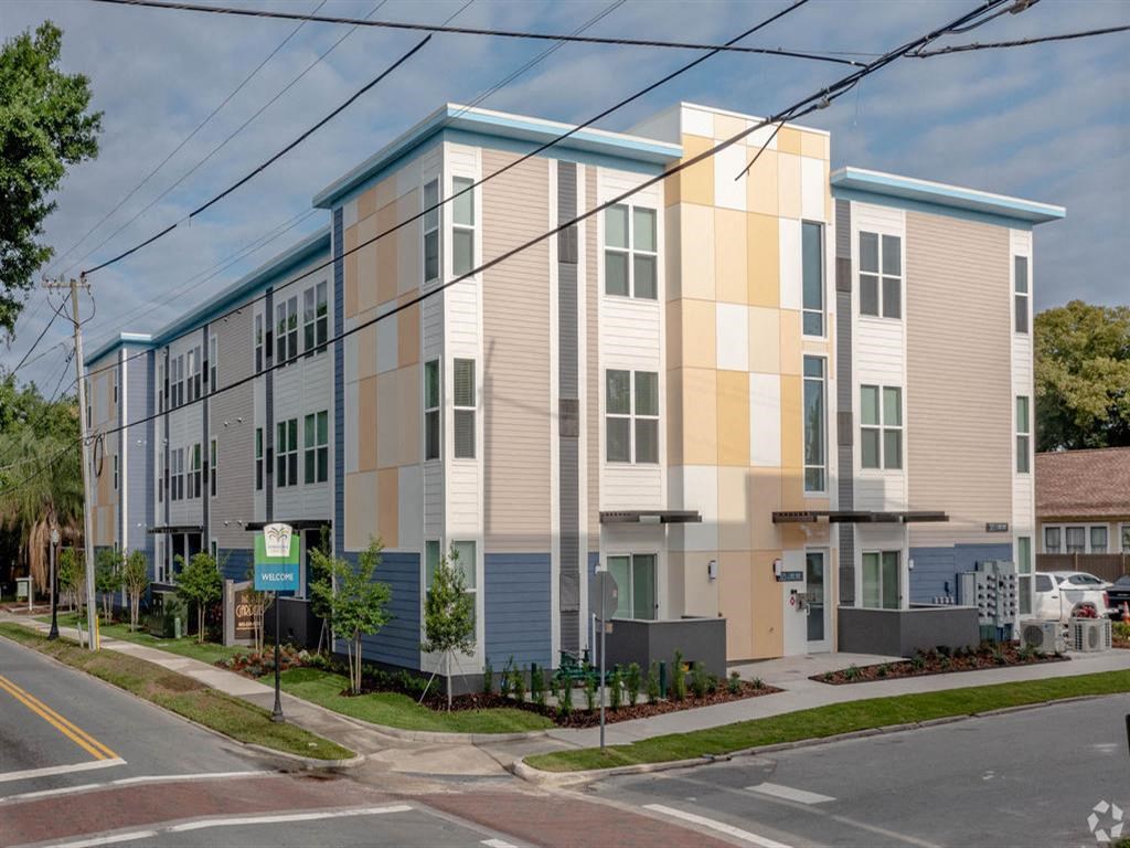 a city street with an apartment building with different colors on it