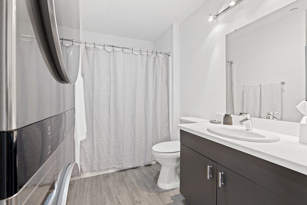 a bathroom with a shower and a sink and a toilet