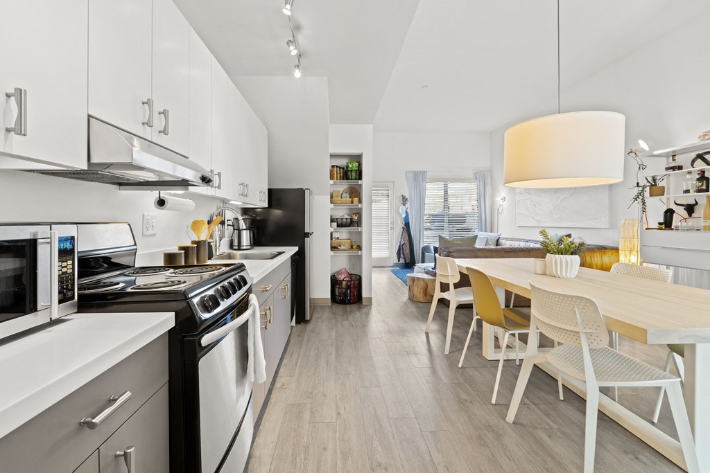a kitchen and dining area with a table and chairs
