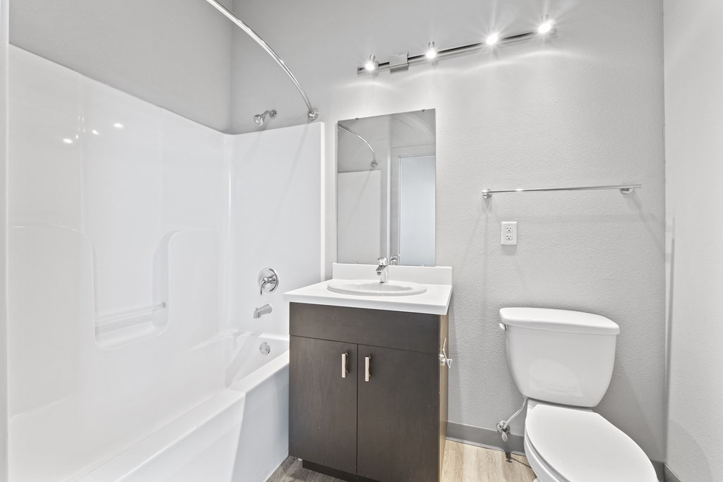 a white bathroom with a toilet sink and shower