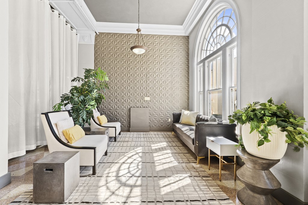 a living room filled with furniture and a large window