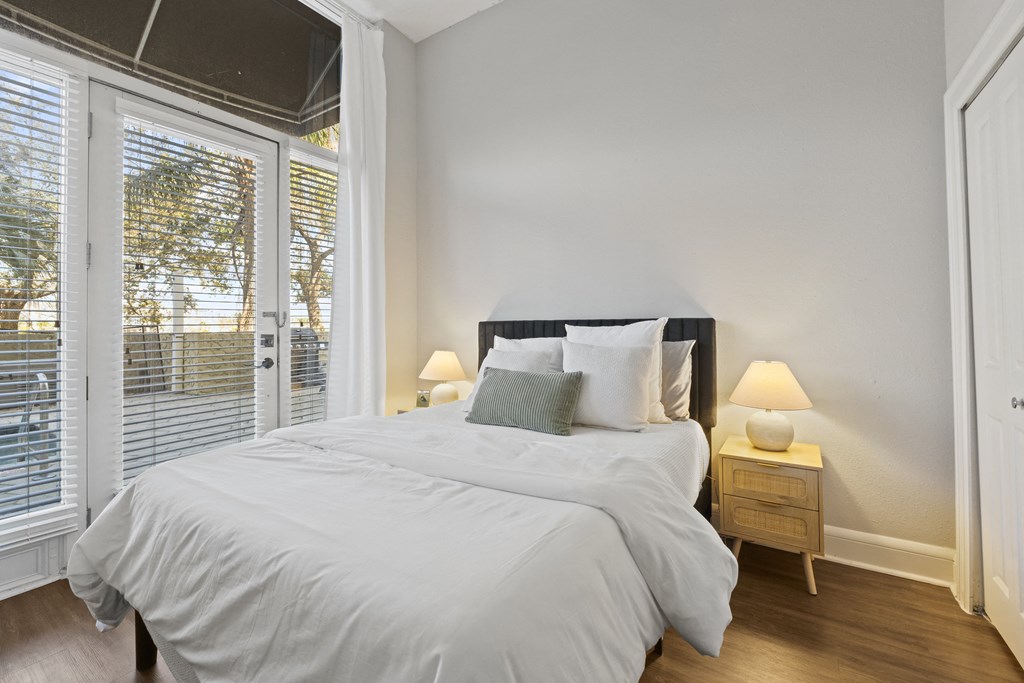 a bedroom with a large bed and a large window