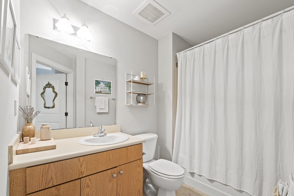 a bathroom with a shower and a toilet and a sink