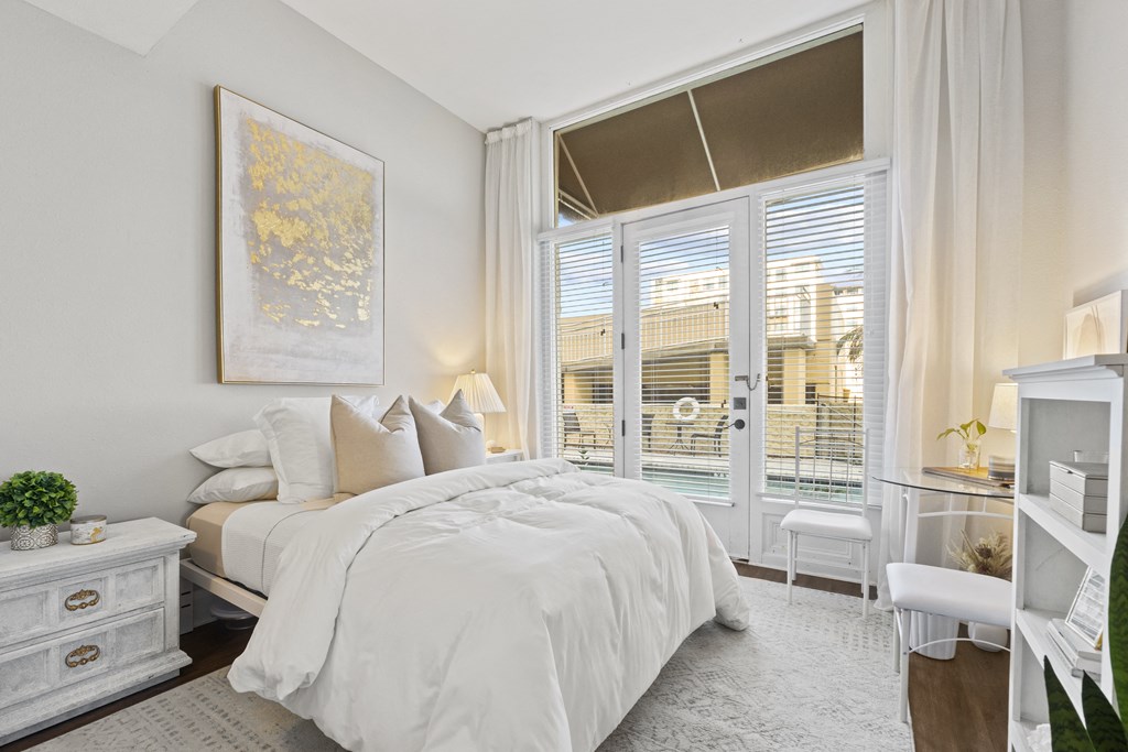 a bedroom with a bed and a large window