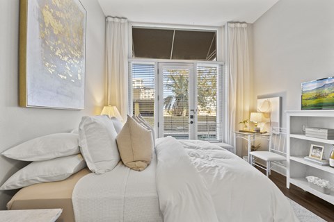 a bedroom with a large bed and a window