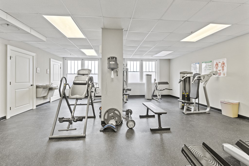 a gym with various machines and weights in it