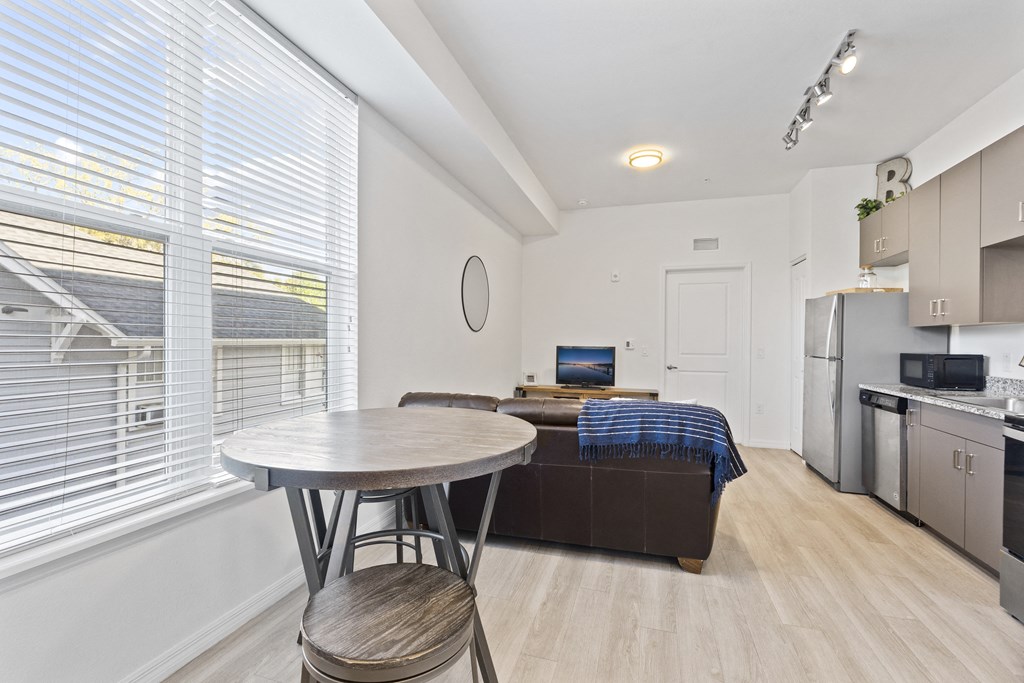 a kitchen and living room with a couch and a table