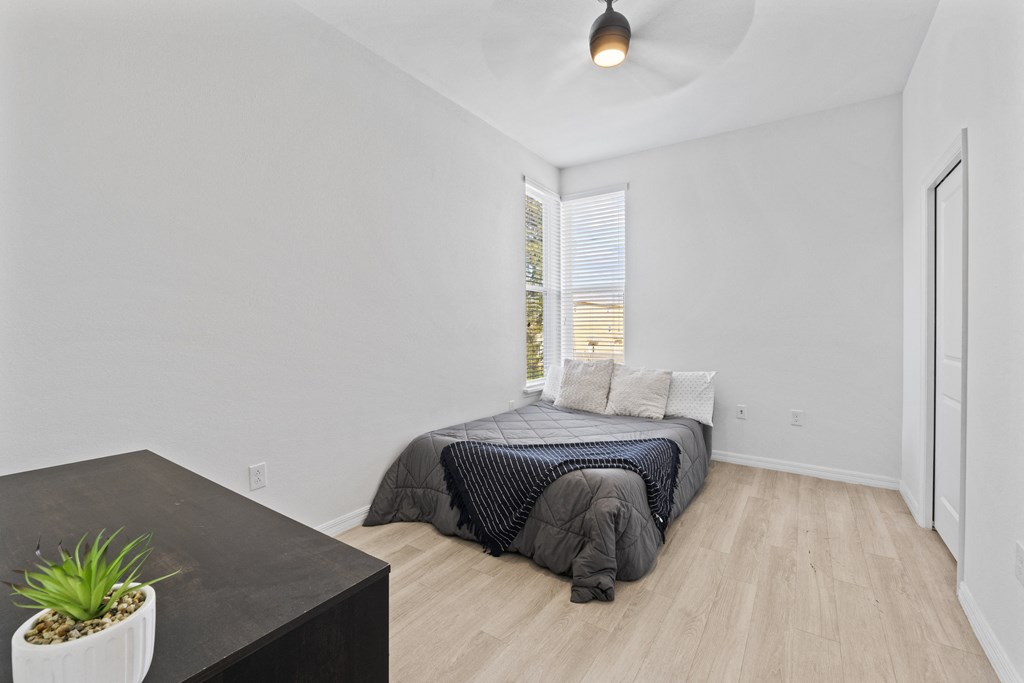 a bedroom with a bed and a large window