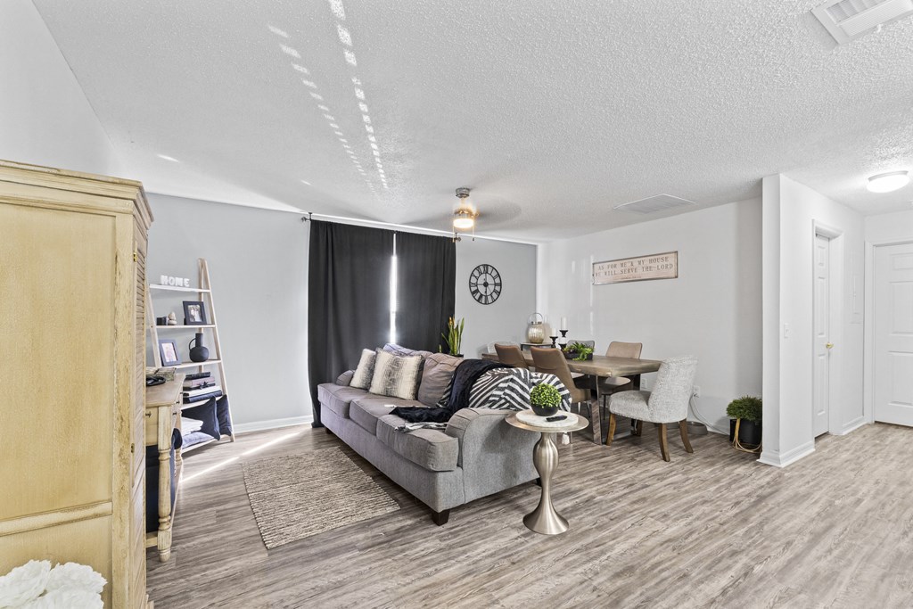 a living room and dining room with a couch and a table